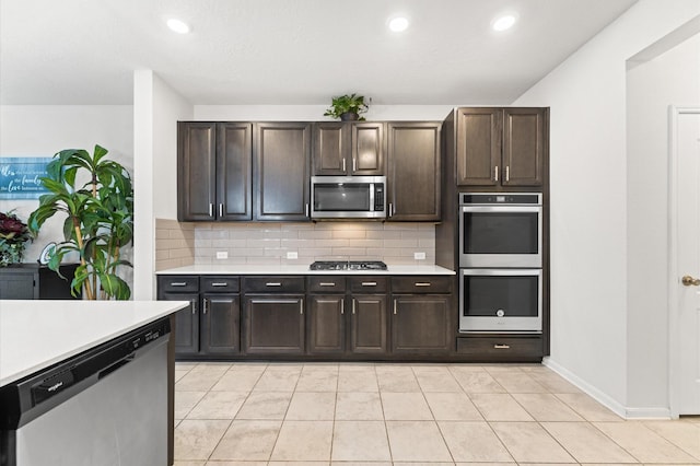 1164 Clonmore Ct, Conroe, TX 77304 - kitchen with stainless steel appliances, light countertops, tasteful backsplash, dark brown cabinetry, and recessed lighting