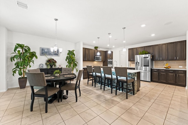 1164 Clonmore Ct, Conroe, TX 77304 - dining area with light tile patterned flooring, recessed lighting, a chandelier, and baseboards