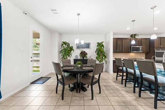 1164 Clonmore Ct, Conroe, TX 77304 - dining space with a chandelier, light tile patterned flooring, baseboards, and recessed lighting