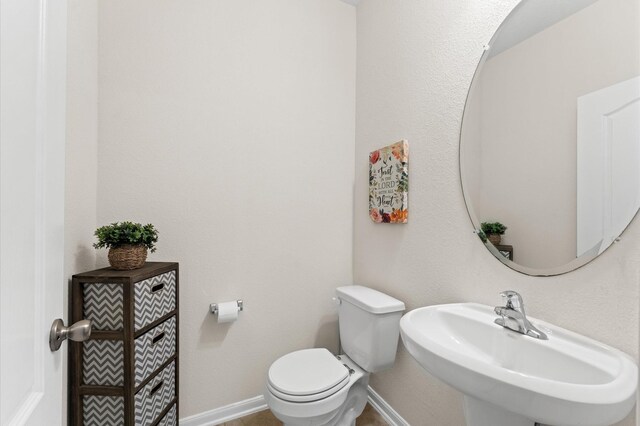 1164 Clonmore Ct, Conroe, TX 77304 - half bathroom featuring a sink and toilet