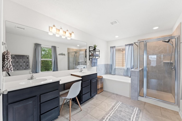 1164 Clonmore Ct, Conroe, TX 77304 - full bath featuring double vanity, a bath, a stall shower, recessed lighting, and tile patterned floors