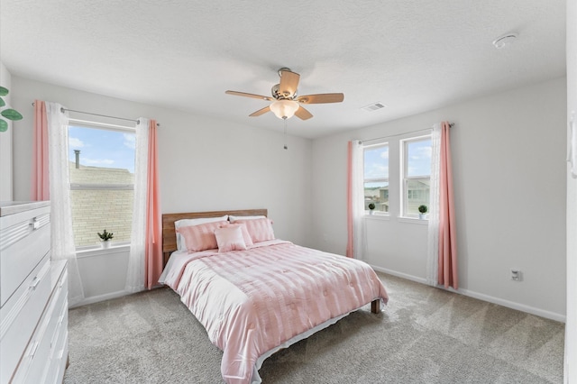 1164 Clonmore Ct, Conroe, TX 77304 - bedroom with light carpet, multiple windows, baseboards, and ceiling fan