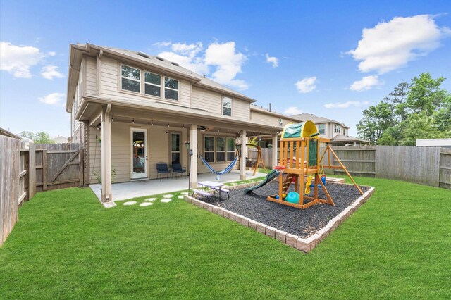 1164 Clonmore Ct, Conroe, TX 77304 - back of house with a patio area, a playground, and a gate