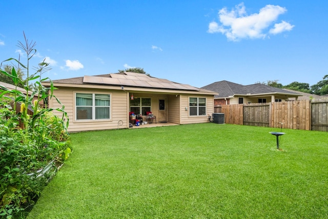12218 Estelle Ln, Pinehurst, TX 77362 - rear view of house with cooling unit, solar panels, and a patio area
