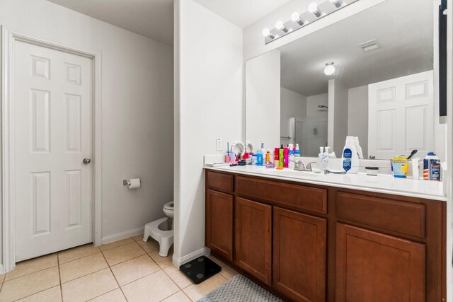 12218 Estelle Ln, Pinehurst, TX 77362 - full bathroom with tile patterned flooring, vanity, toilet, baseboards, and a shower