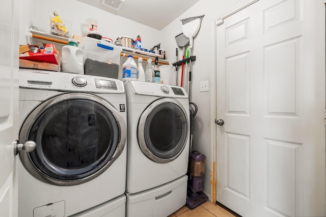 12218 Estelle Ln, Pinehurst, TX 77362 - laundry area featuring independent washer and dryer and light tile patterned floors