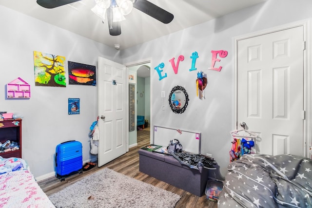12218 Estelle Ln, Pinehurst, TX 77362 - bedroom featuring wood finished floors, baseboards, a ceiling fan, and arched walkways