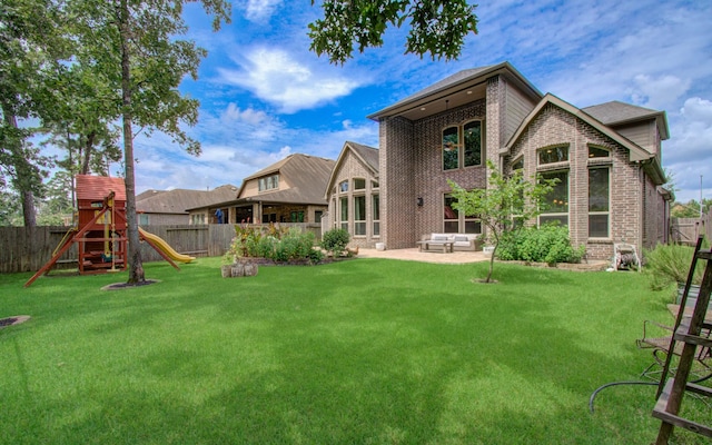 31297 New Forest Park Ln, Spring, TX 77386 - back of house with a fenced backyard, brick siding, and a playground