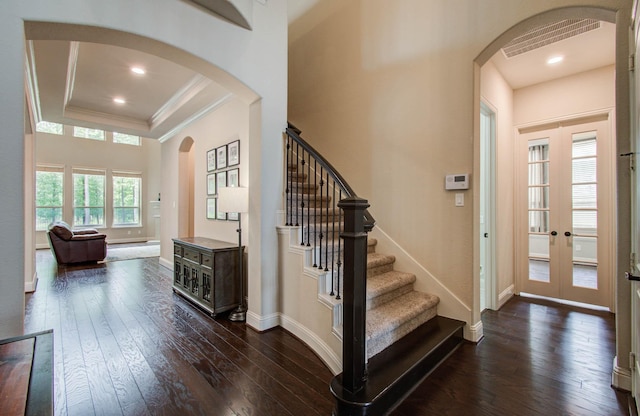 31297 New Forest Park Ln, Spring, TX 77386 - foyer featuring ornamental molding, arched walkways, dark wood-style floors, stairway, and french doors