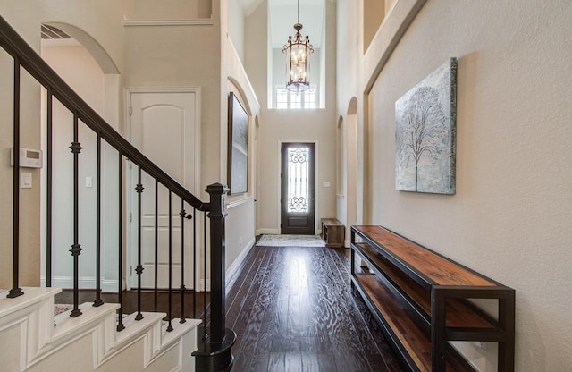 31297 New Forest Park Ln, Spring, TX 77386 - foyer with wood finished floors, arched walkways, a chandelier, a towering ceiling, and stairway