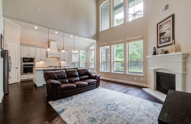 31297 New Forest Park Ln, Spring, TX 77386 - living room with a high ceiling, dark wood finished floors, a premium fireplace, and recessed lighting