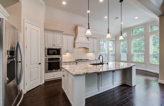 31297 New Forest Park Ln, Spring, TX 77386 - kitchen with appliances with stainless steel finishes, ornamental molding, custom exhaust hood, light stone countertops, and dark wood-type flooring