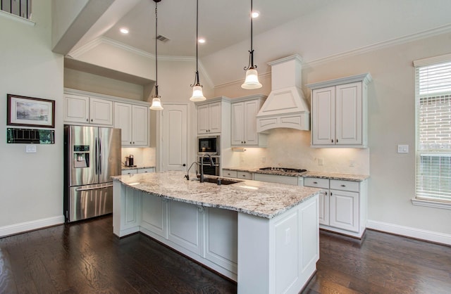 31297 New Forest Park Ln, Spring, TX 77386 - kitchen with stainless steel appliances, an island with sink, light stone counters, dark wood-style flooring, and ornamental molding