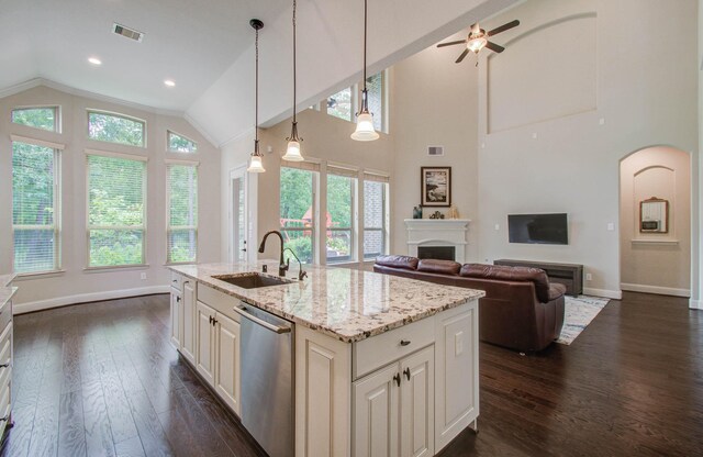 31297 New Forest Park Ln, Spring, TX 77386 - kitchen with dishwasher, a fireplace, dark wood-type flooring, ceiling fan, and high vaulted ceiling