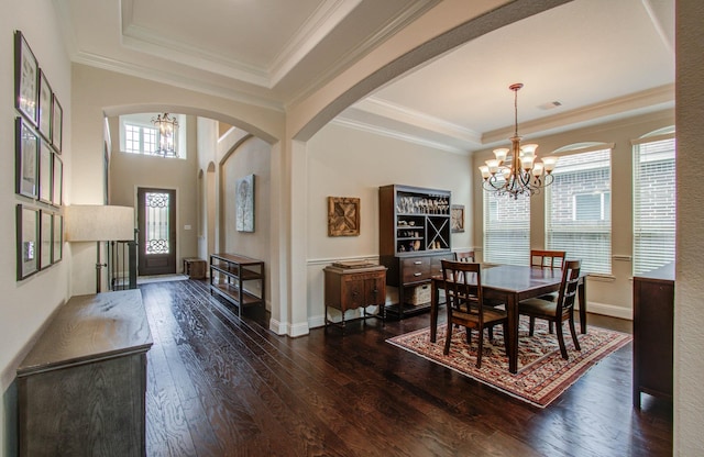 31297 New Forest Park Ln, Spring, TX 77386 - dining space featuring a chandelier, a raised ceiling, arched walkways, dark wood-type flooring, and ornamental molding