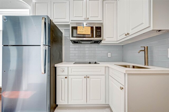 825 W 16th St Unit A, Houston, TX 77008 - kitchen with stainless steel appliances, a sink, light countertops, and tasteful backsplash