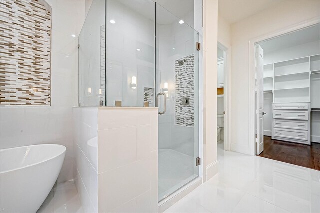 825 W 16th St Unit A, Houston, TX 77008 - full bathroom featuring a shower stall, a walk in closet, a freestanding bath, and tile patterned floors