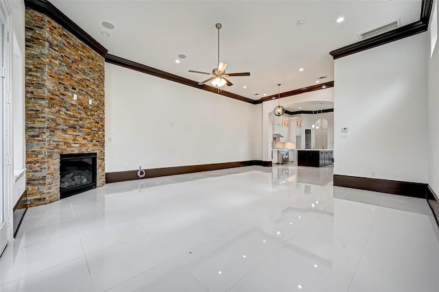 825 W 16th St Unit A, Houston, TX 77008 - unfurnished living room featuring ornamental molding, ceiling fan, tile patterned flooring, a stone fireplace, and recessed lighting