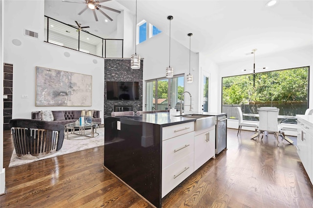2310 Althea Dr, Houston, TX 77018 - kitchen featuring ceiling fan, a high ceiling, dark wood finished floors, dark countertops, and white cabinetry