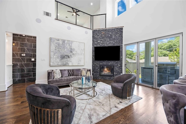 2310 Althea Dr, Houston, TX 77018 - living room featuring a towering ceiling, plenty of natural light, a glass covered fireplace, wood finished floors, and ceiling fan