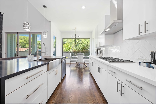 2310 Althea Dr, Houston, TX 77018 - kitchen with wall chimney range hood, a sink, stainless steel appliances, dark wood finished floors, and healthy amount of natural light
