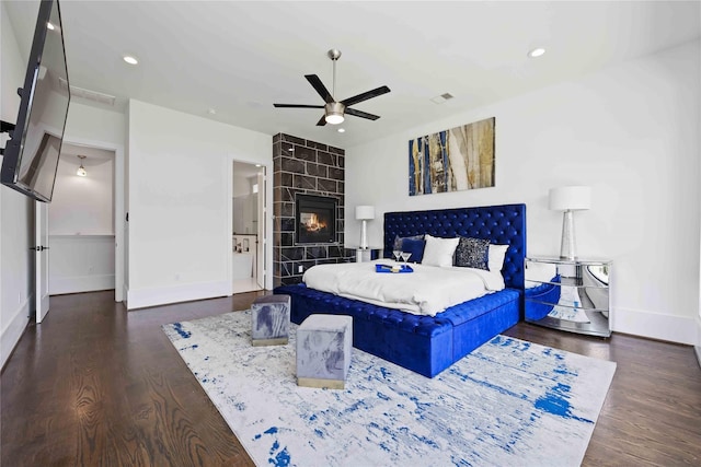 2310 Althea Dr, Houston, TX 77018 - bedroom with baseboards, wood finished floors, a ceiling fan, recessed lighting, and a tile fireplace