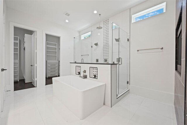 2310 Althea Dr, Houston, TX 77018 - bathroom featuring a shower stall, plenty of natural light, a soaking tub, a walk in closet, and recessed lighting