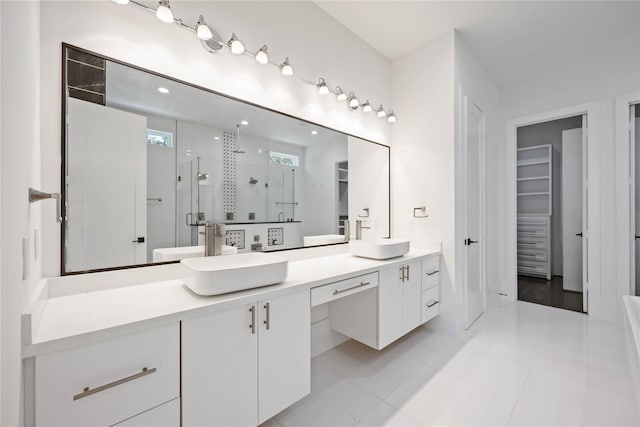 2310 Althea Dr, Houston, TX 77018 - bathroom with a shower stall, double vanity, a walk in closet, and tile patterned floors