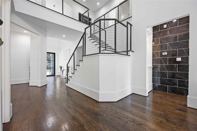 2310 Althea Dr, Houston, TX 77018 - entrance foyer featuring a high ceiling, tile walls, stairs, wood finished floors, and baseboards
