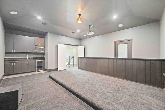 2310 Althea Dr, Houston, TX 77018 - kitchen featuring wine cooler, stainless steel microwave, a sink, carpet floors, and gray cabinetry