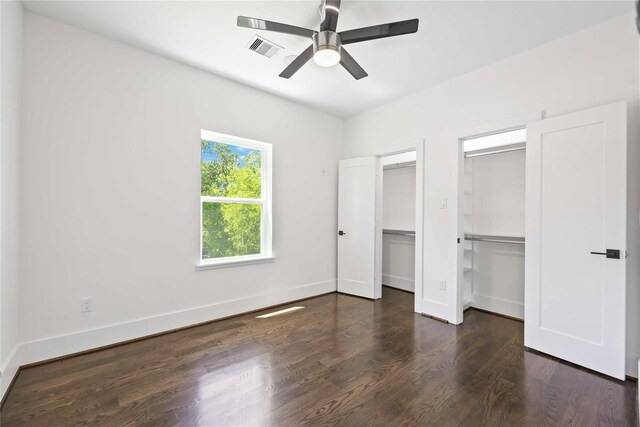 2310 Althea Dr, Houston, TX 77018 - unfurnished bedroom featuring multiple closets, wood finished floors, baseboards, and a ceiling fan