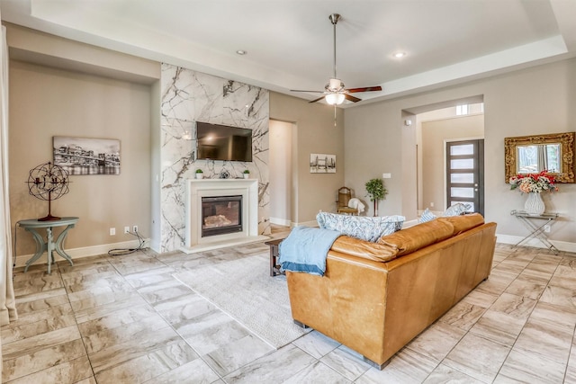 1010 Zoyas Creek Trl, Katy, TX 77494 - living area with light marble finish floors, a ceiling fan, a fireplace, baseboards, and recessed lighting