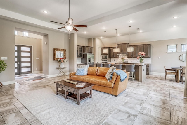 1010 Zoyas Creek Trl, Katy, TX 77494 - living room with ceiling fan, recessed lighting, baseboards, and light marble finish floors