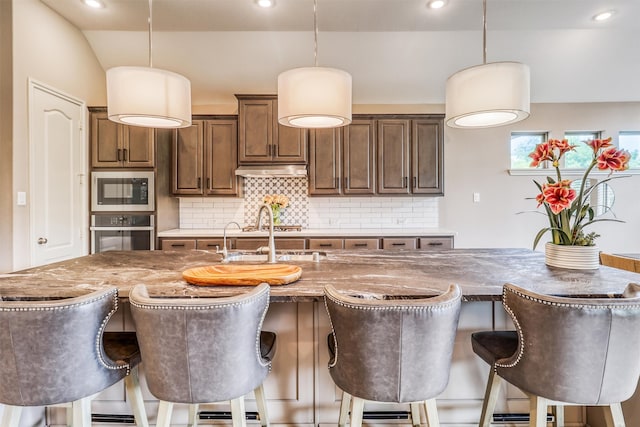 1010 Zoyas Creek Trl, Katy, TX 77494 - kitchen featuring wall oven, built in microwave, tasteful backsplash, decorative light fixtures, and recessed lighting