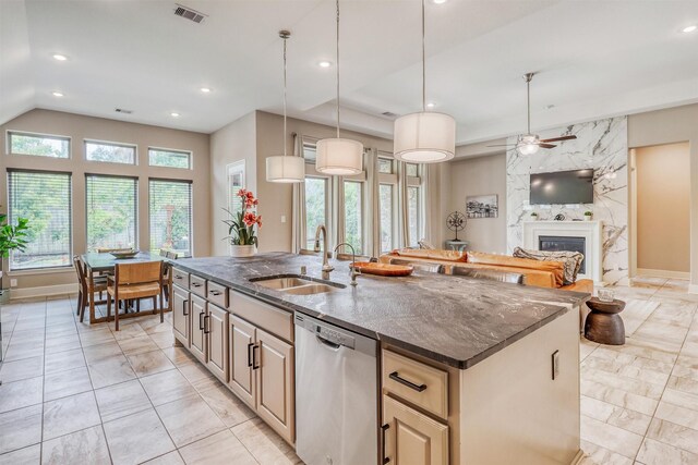 1010 Zoyas Creek Trl, Katy, TX 77494 - kitchen with dishwasher, a sink, light marble finish flooring, an island with sink, and a premium fireplace
