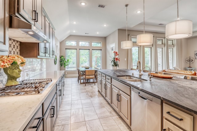 1010 Zoyas Creek Trl, Katy, TX 77494 - kitchen with stainless steel appliances, a sink, dark stone counters, light marble finish floors, and recessed lighting