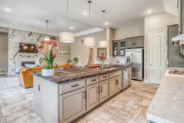 1010 Zoyas Creek Trl, Katy, TX 77494 - kitchen with a sink, stainless steel appliances, light marble finish flooring, a kitchen island with sink, and dark stone countertops