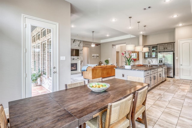 1010 Zoyas Creek Trl, Katy, TX 77494 - dining area featuring a fireplace, recessed lighting, and a ceiling fan