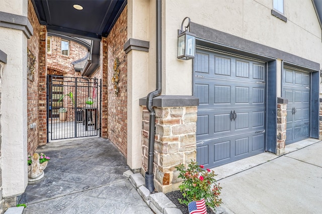 1010 Zoyas Creek Trl, Katy, TX 77494 - entrance to property featuring stucco siding, a gate, driveway, brick siding, and a garage