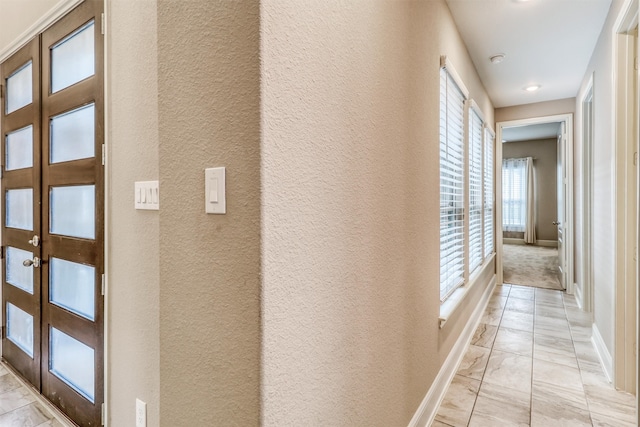 1010 Zoyas Creek Trl, Katy, TX 77494 - corridor featuring a textured wall, baseboards, french doors, and light marble finish flooring