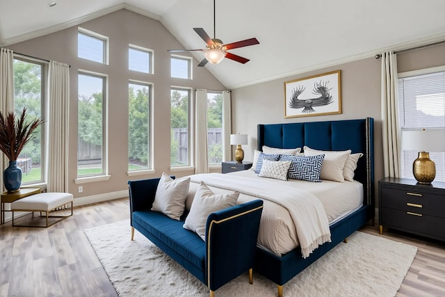 1010 Zoyas Creek Trl, Katy, TX 77494 - bedroom featuring multiple windows, vaulted ceiling, light wood finished floors, and a ceiling fan