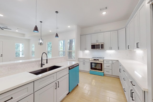 117 Keaau Ct, Bastrop, TX 78602 - kitchen with appliances with stainless steel finishes, a sink, decorative backsplash, recessed lighting, and pendant lighting