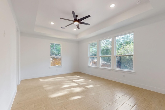 117 Keaau Ct, Bastrop, TX 78602 - empty room featuring a raised ceiling, ceiling fan, recessed lighting, and baseboards