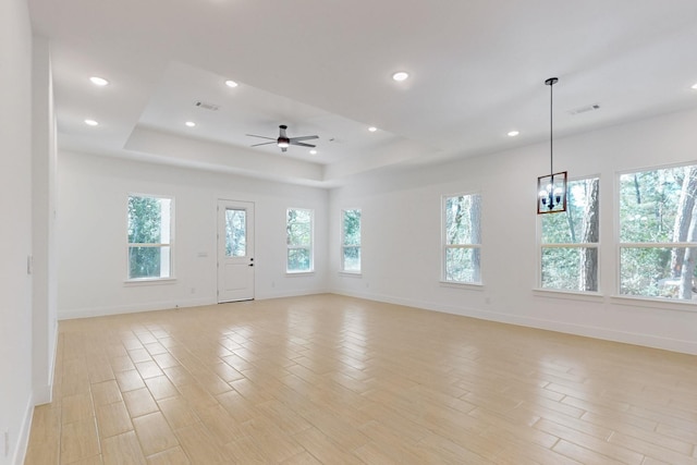 117 Keaau Ct, Bastrop, TX 78602 - unfurnished room featuring baseboards, a tray ceiling, light wood-style floors, a ceiling fan, and recessed lighting