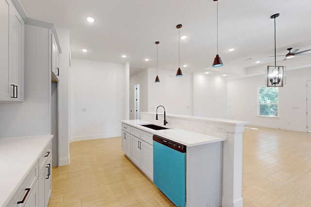 117 Keaau Ct, Bastrop, TX 78602 - kitchen with dishwashing machine, a sink, open floor plan, a kitchen island with sink, and light countertops