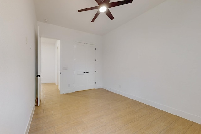 117 Keaau Ct, Bastrop, TX 78602 - unfurnished bedroom with baseboards, light wood-style floors, and ceiling fan