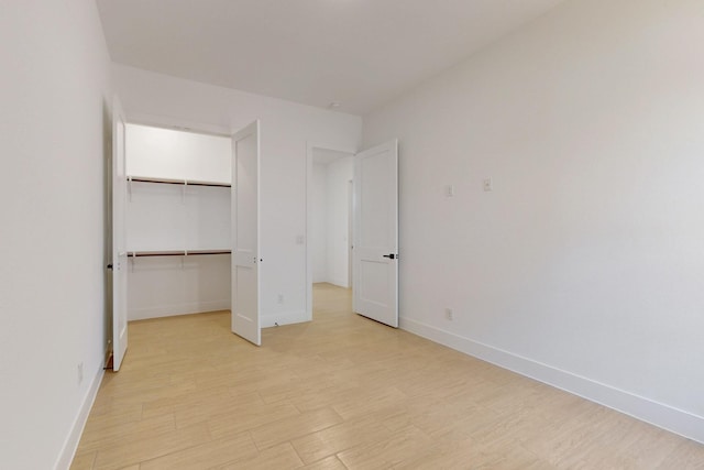 117 Keaau Ct, Bastrop, TX 78602 - unfurnished bedroom featuring light wood-type flooring, baseboards, and a spacious closet