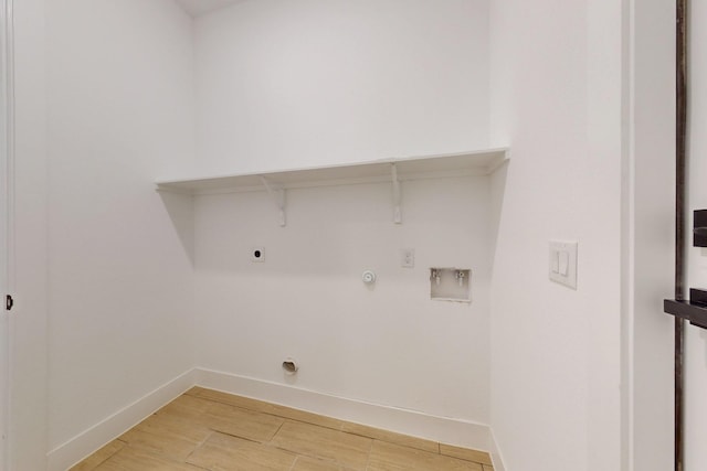 117 Keaau Ct, Bastrop, TX 78602 - laundry area with hookup for an electric dryer, baseboards, hookup for a washing machine, hookup for a gas dryer, and light wood-type flooring