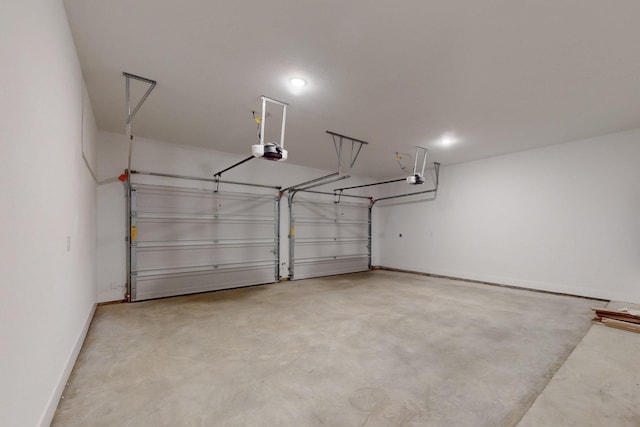 117 Keaau Ct, Bastrop, TX 78602 - garage featuring a garage door opener and baseboards