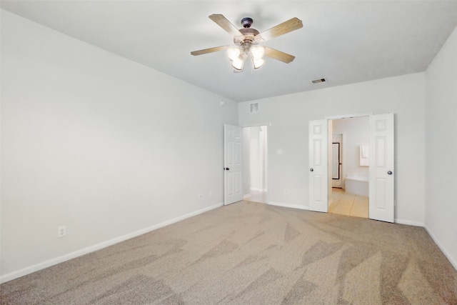 9034 Cedar Run Fls, Tomball, TX 77375 - unfurnished bedroom with light colored carpet, baseboards, ensuite bathroom, and a ceiling fan